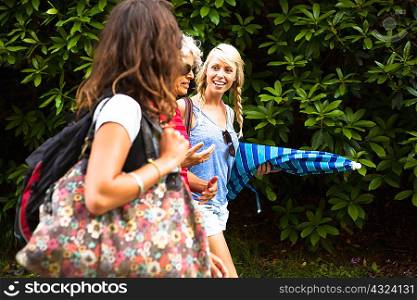 Mature mother and two daughters chatting and walking