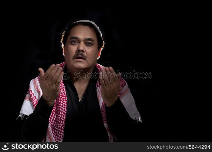 Mature Muslim man praying