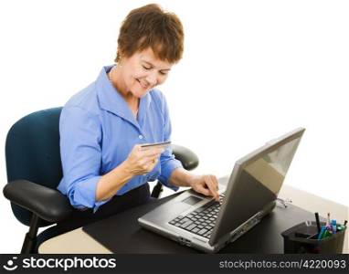 Mature office worker takes a few minutes to shop on the internet. Isolated on white.