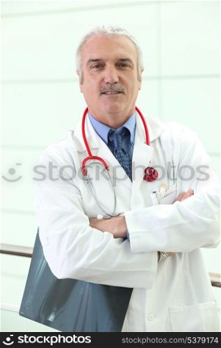 mature physician with folded arms