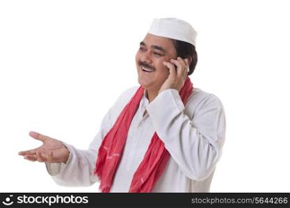 Mature politician gesturing while having conversation on mobile phone