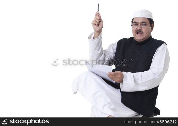 Mature politician holding papers and giving speech