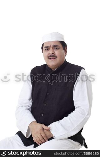Mature politician sitting over white background