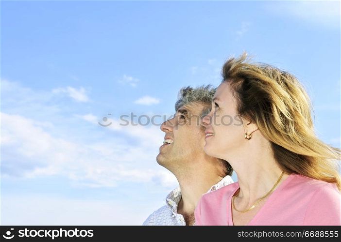 Mature romantic couple of baby boomers looking at the sky