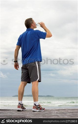 Mature runner drinking water