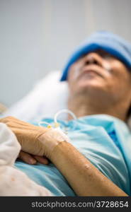 mature senior man Patient sleeping in hospital bed (Selective focus at hand)