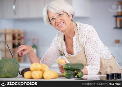 mature smiling woman with fruits and vegetables
