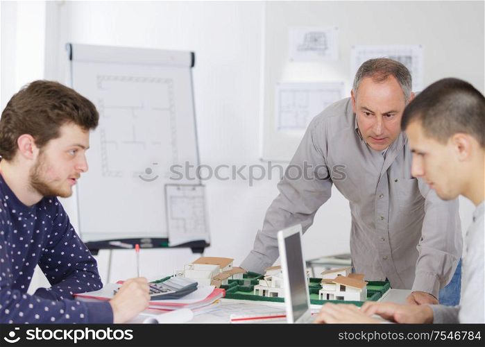 mature teacher and students in computer lab classroom
