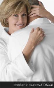 Mature woman and a senior man embracing each other