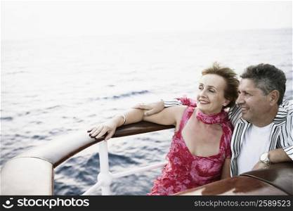 Mature woman and a senior man smiling in a ship