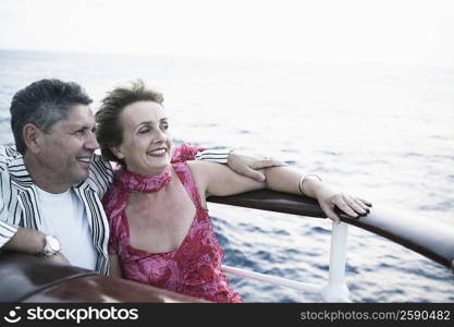 Mature woman and a senior man smiling in a ship