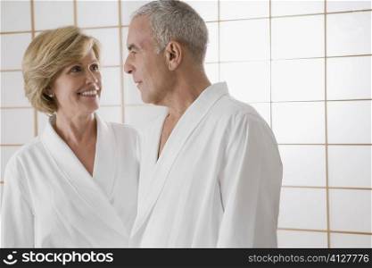 Mature woman and a senior man standing in the bathroom