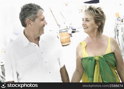 Mature woman and a senior man standing together and looking at each other