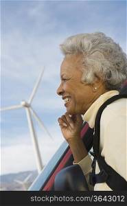 Mature woman by wind farm