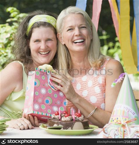 Mature woman celebrating her birthday with her friend