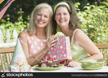 Mature woman celebrating her birthday with her friend