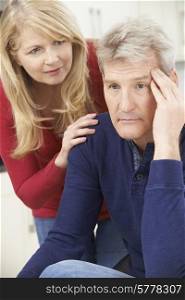 Mature Woman Comforting Man With Depression