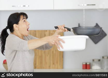 mature woman dealing with a leak