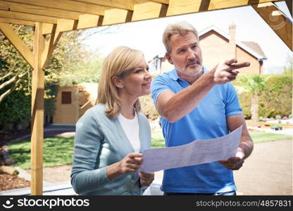 Mature Woman Discussing Plan With Landscape Gardener