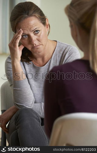 Mature Woman Discussing Problems With Counselor