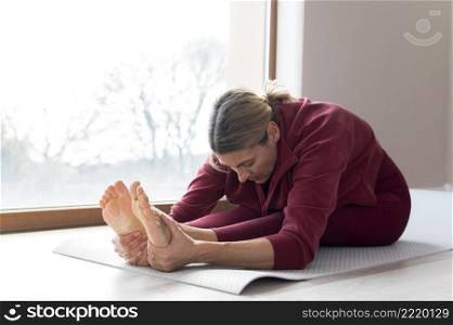 mature woman doing sport exercises her window