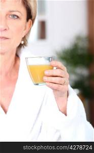 Mature woman drinking juice