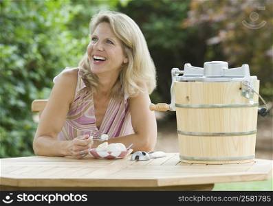 Mature woman eating an ice cream and smiling