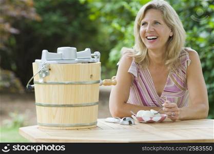 Mature woman eating an ice cream and smiling
