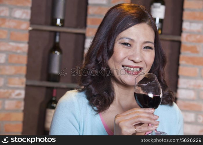 Mature Woman Enjoying a Glass of Wine