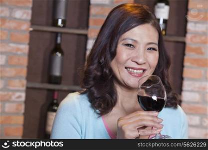 Mature Woman Enjoying a Glass of Wine