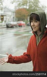 Mature woman examining rain