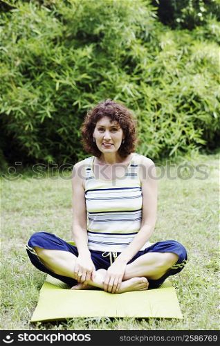 Mature woman exercising on the lawn