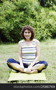 Mature woman exercising on the lawn