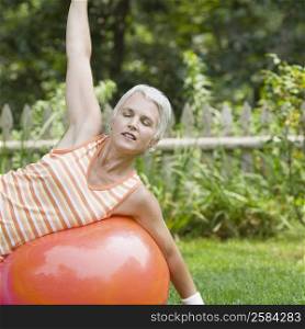 Mature woman exercising with a fitness ball