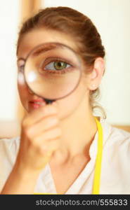 Mature woman female looking through magnifying glass. Investigation or exploration concept.. Woman looking through magnifying glass.