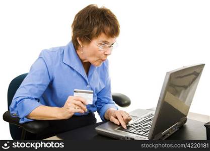 Mature woman finds a bargain shopping online. Isolated on white.