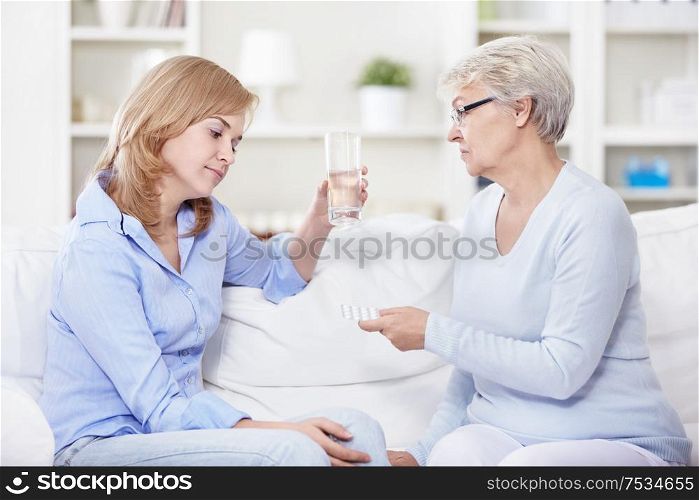 Mature woman gives a young woman pills