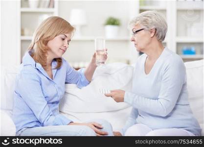 Mature woman gives a young woman pills