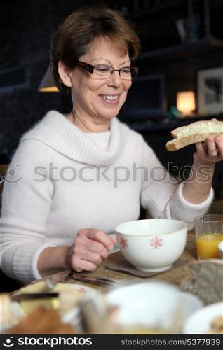Mature woman having a winter breakfast