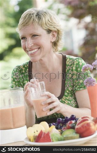 Mature woman having breakfast and smiling