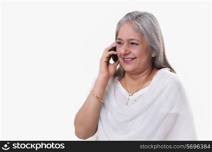 Mature woman having conversation on mobile phone