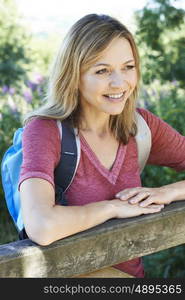 Mature Woman Hiking In Countryside