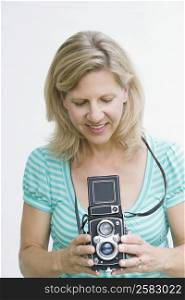 Mature woman holding a camera