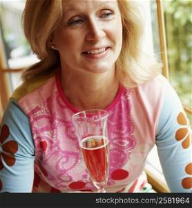Mature woman holding a champagne flute and smiling