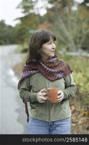 Mature woman holding a coffee cup and smiling