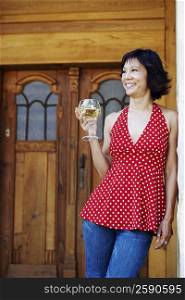 Mature woman holding a glass of white wine