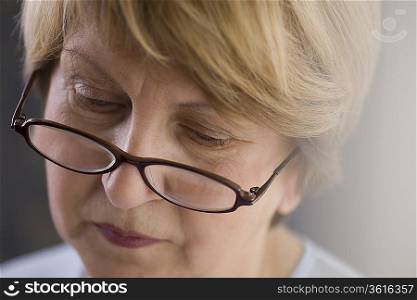 Mature woman in reading glasses