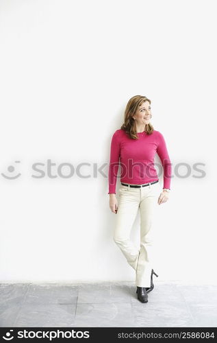 Mature woman leaning against a wall