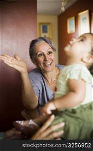 Mature woman looking at her granddaughter and smiling