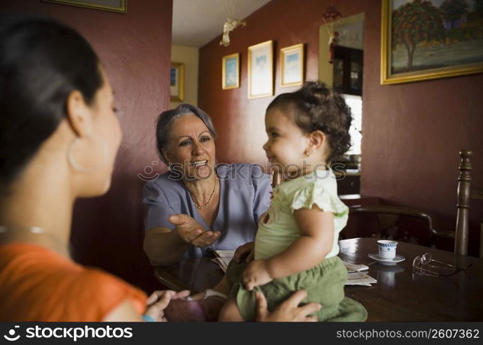 Mature woman looking at her granddaughter with another standing beside her